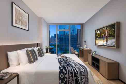 Modern hotel room at Chengdu Gaoxin Aparthotel with city views and contemporary decor.