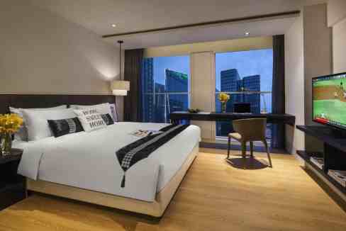 Modern hotel room at Chengdu South Aparthotel with city views and contemporary decor.