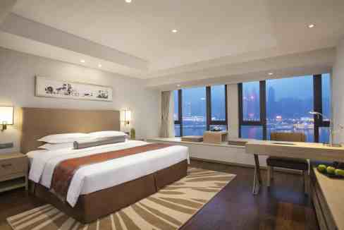 Modern room at Chongqing Yangtze River Aparthotel with skyline views and contemporary decor.