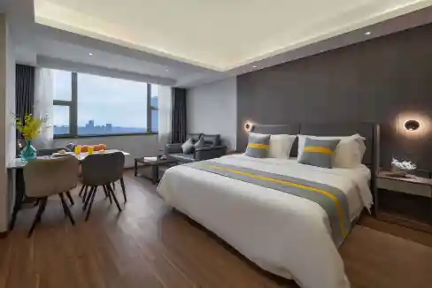 Hotel suite with contemporary design, large bed, and scenic cityscape in Hefei.