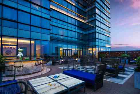 Rooftop terrace at Nantong Xinfucun Aparthotel with modern outdoor seating and city views.