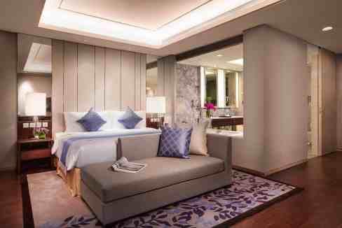Elegant hotel room at Shanghai Heng Shan Aparthotel with modern decor and comfortable furnishings.
