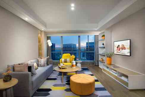 Spacious living room with large windows, contemporary furniture, and cityscape view at Shaoxing Keqi.