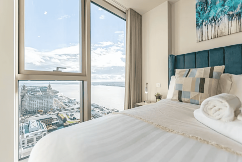 Modern bedroom with city views in Liverpool's Lexington Apartments.