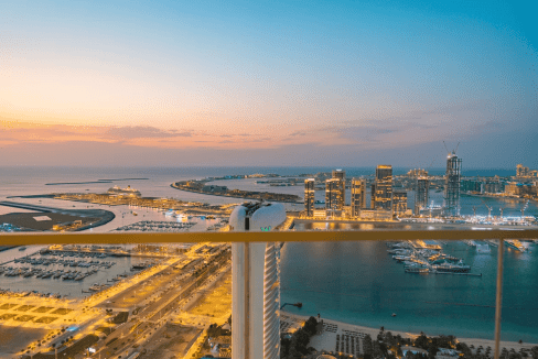 Marina Beach view from high-rise apartment balcony at sunset.
