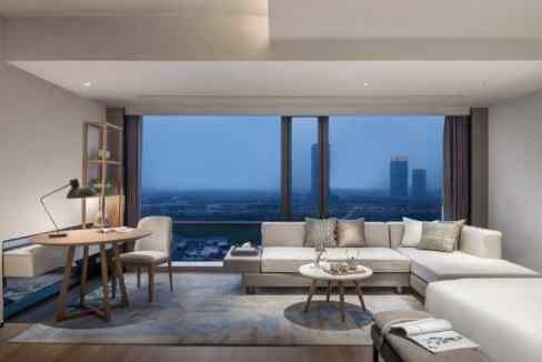 Spacious living room with city views at Hangzhou Riverside Aparthotel.
