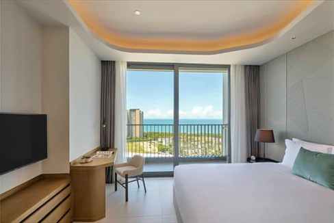 Modern hotel room with ocean view in Sanya Bay Aparthotel.