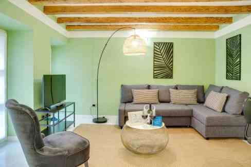 Stylish living room in Palazzo Di Giustizia Apartments with modern furniture and cozy ambiance.