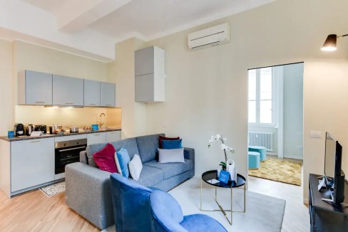 Bright and stylish living space in Giambologna Apartments with contemporary furniture and natural li.