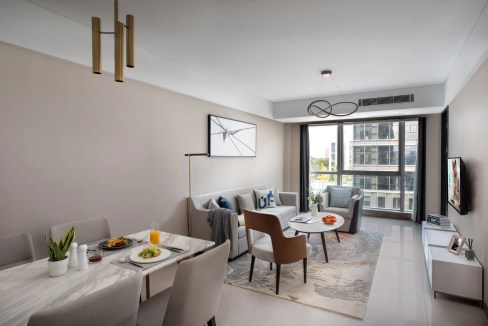Modern living room in Wuxi New District Aparthotel with stylish furniture and city views.