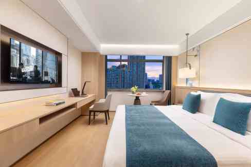 Modern hotel room in Wuxi Gongyun District with city views and contemporary decor.