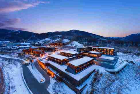Aparthotel at Chongli Ski Resort with snow-covered buildings and mountain views.