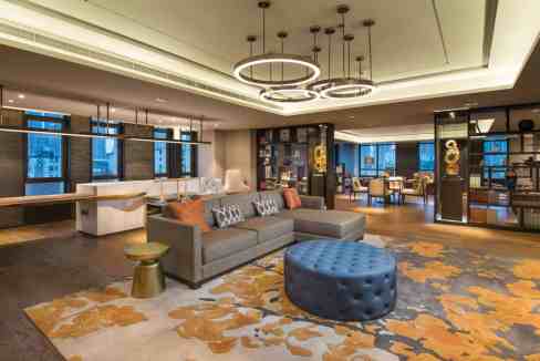 Elegant hotel lobby featuring contemporary furnishings and stylish lighting fixtures.