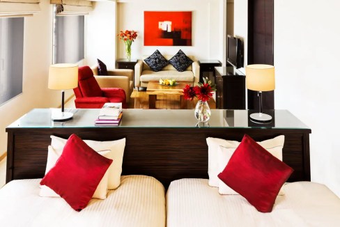 Stylish Tokyo Shinjuku Aparthotel living room with modern furniture and vibrant accents.