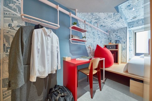 Stylish Tokyo Kyobashi Aparthotel room featuring a workspace, clothing rack, and modern design.