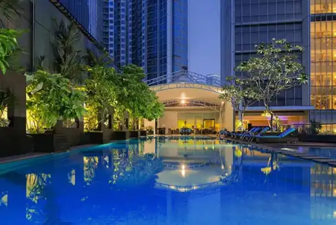 Pool area at Jakarta Mega Kuningan Aparthotel with modern high-rise buildings in the background.