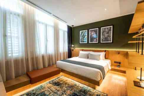 Modern bedroom at Penang Macalister Aparthotel with stylish decor and natural light.