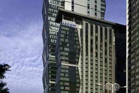 Imposing Kuala Lumpur skyscraper with unique architectural design and glass facade.