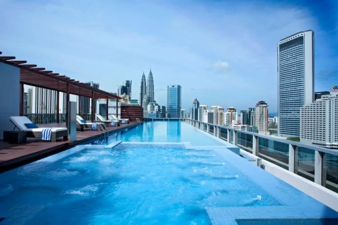 Rooftop infinity pool with city views in Kuala Lumpur, near Ampang Park. Modern luxury with iconic s.