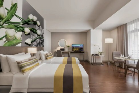 Modern Manila Aparthotel room with stylish decor and comfortable bedding.