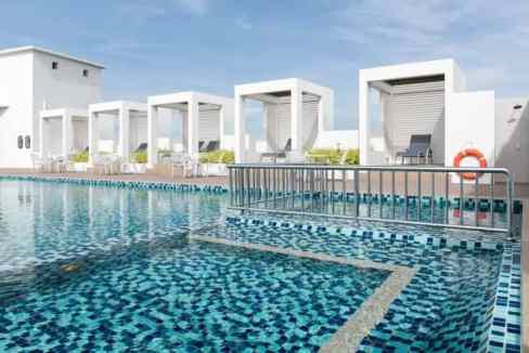 Relaxing pool with modern cabanas at Penang Prai Aparthotel, perfect for leisure and relaxation.