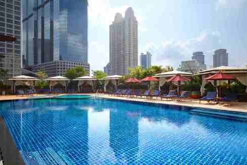Rooftop pool at Bangkok Saint Louis Aparthotel with city skyline view.