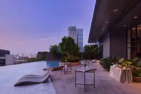 Rooftop pool and lounge at Bangkok Rama 9 Aparthotel with city views and modern amenities.