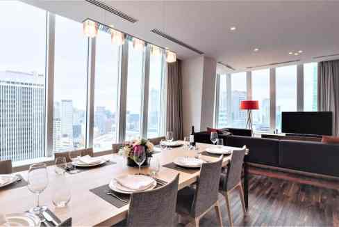 Modern Tokyo Roppongi T-Cube apartment interior with dining area and city view.