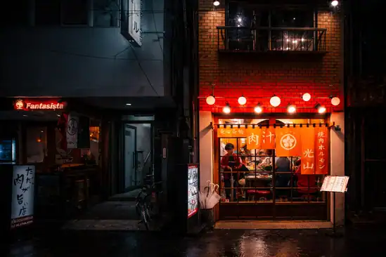 Nighttime Tokyo street food stall with warm lighting and traditional Japanese decor.