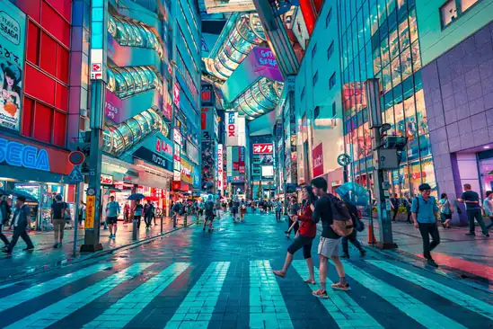 Bustling Tokyo street with neon signs and pedestrians in a lively urban setting.