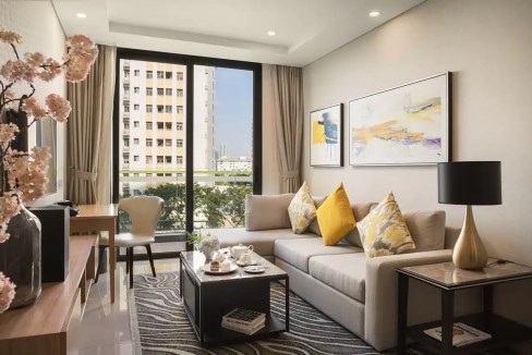 Stylish living room with large window overlooking cityscape at Tan Phong Aparthotel. Comfortable sof.