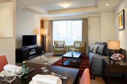 Comfortable living space at Tokyo Aoyama Aparthotel featuring contemporary decor and cozy seating ar.