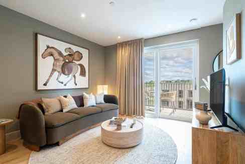 Modern living room with balcony view, cozy sofa, and contemporary decor.