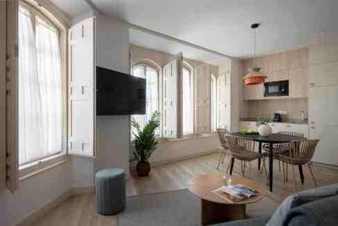 Spacious living area featuring large windows, natural light, and contemporary furniture.