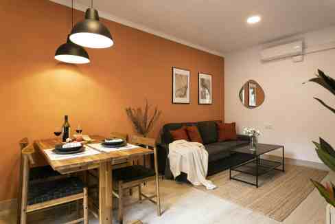 Cozy living room and dining space with stylish decor and warm lighting.