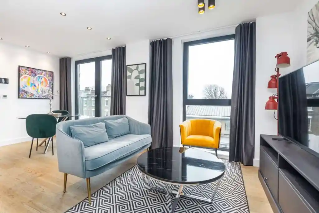 Bright and airy living room featuring a blue sofa, yellow armchair, and contemporary decor.