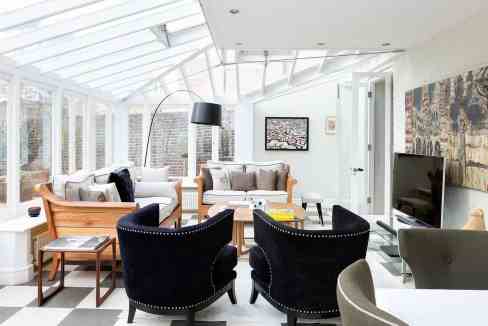 Bright, airy living room featuring contemporary furniture and large windows letting in natural light.