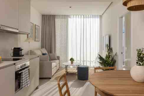 Bright living room with large window, neutral tones, and contemporary furniture.