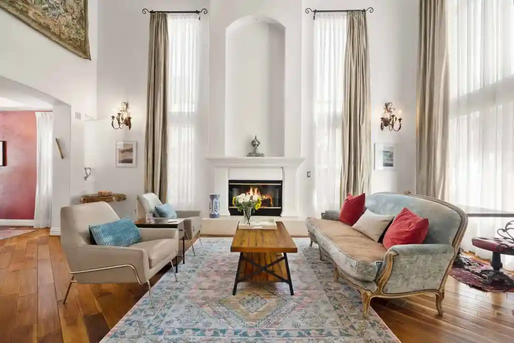 Elegant living room with high ceilings, large windows, and classic furniture for a sophisticated hom.