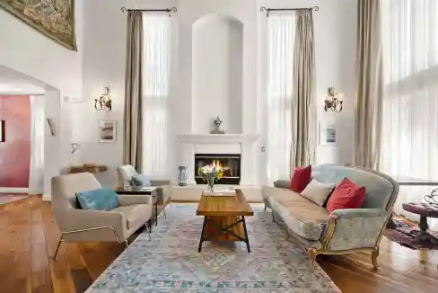 Elegant living room with high ceilings, large windows, and classic furniture for a sophisticated hom.