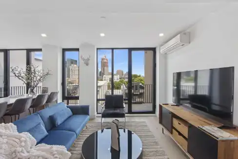 Rooftop apartment interior with city views, stylish furniture, and natural light in Greenpoint.