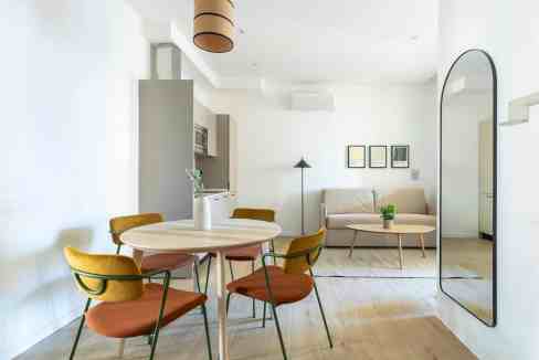 Stylish modern living and dining room with minimalist design, cozy seating, and contemporary decor e.