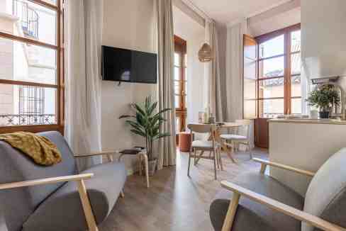 Bright living room with large windows and modern furniture.