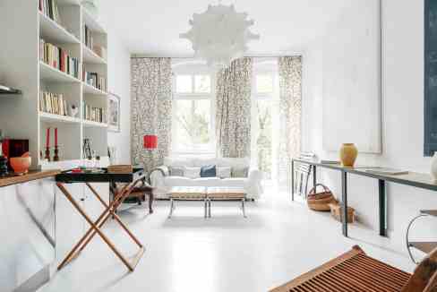 Bright living room with large windows, white walls, and contemporary decor. Perfect for cozy, stylis.