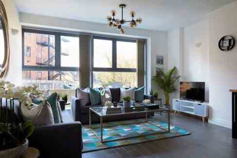 Bright living room with large windows, contemporary furniture, and vibrant accents.