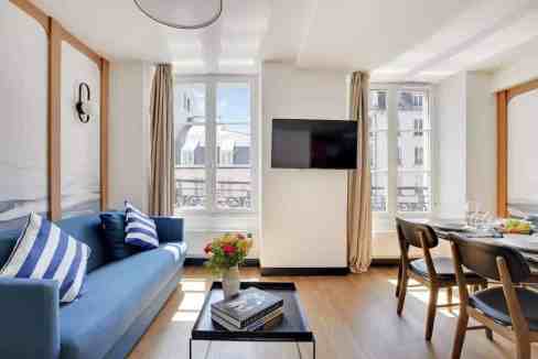 Bright and stylish living room in a Paris serviced apartment with modern decor.