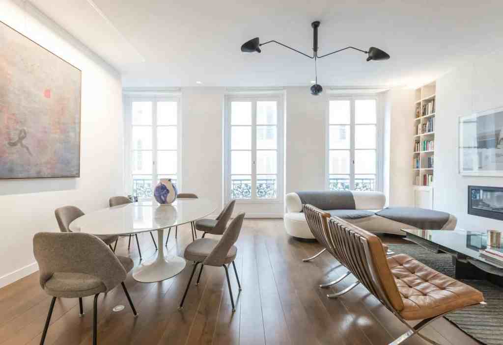 Bright living room with large windows, contemporary furniture, and artwork.