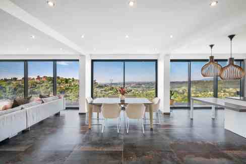 Bright living room with panoramic city views and modern decor.