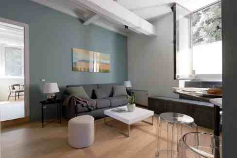 Modern living room with large window, minimalist furniture, and calming color palette for stylish ho.