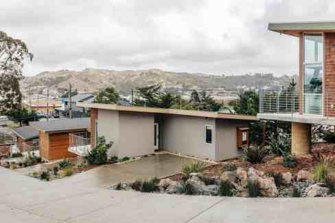 Contemporary coastal homes with scenic hillside views and modern architecture.